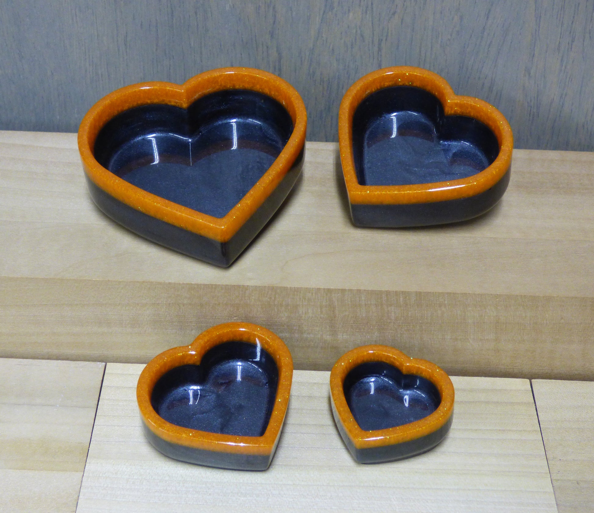 Set of four resin silver black and orange heart shaped dishes 