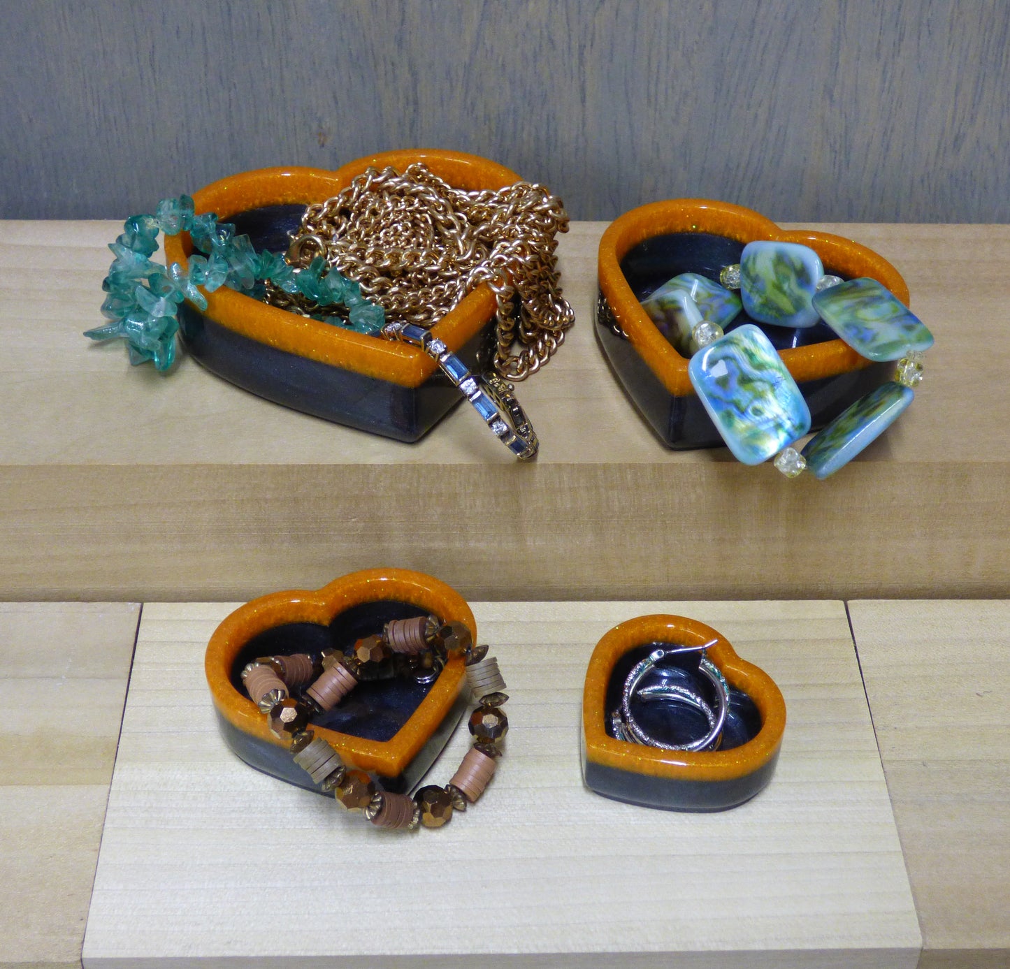 Set of four resin silver black and orange heart shaped dishes 