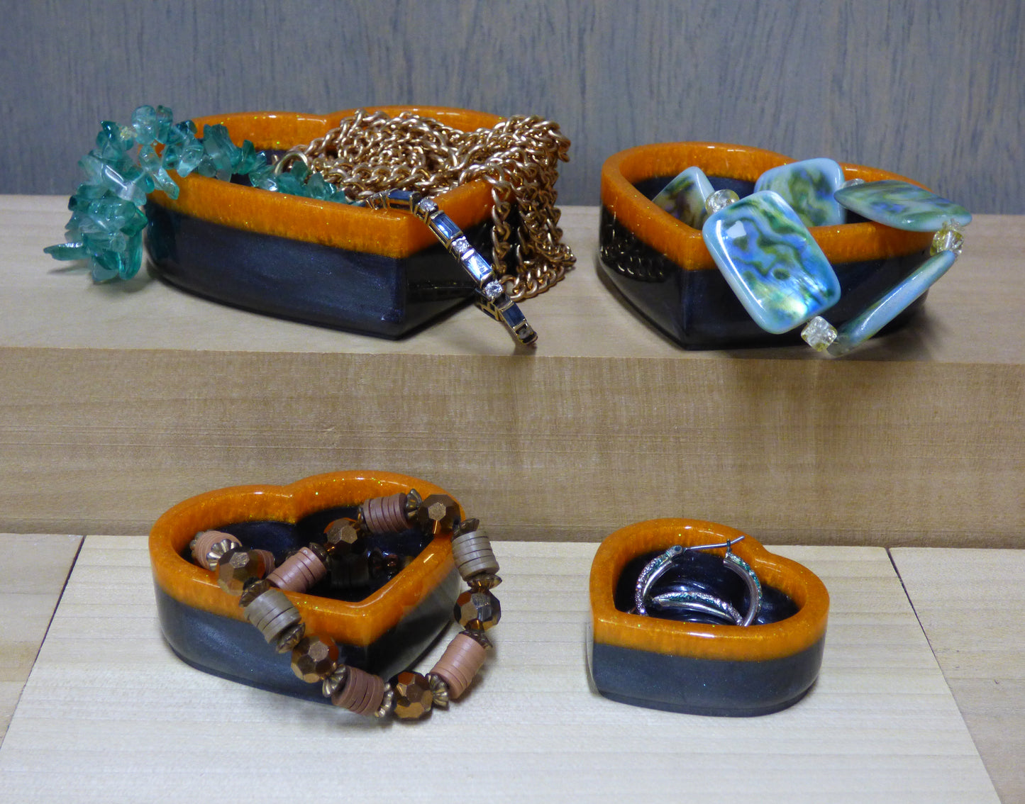 Set of four resin silver black and orange heart shaped dishes 