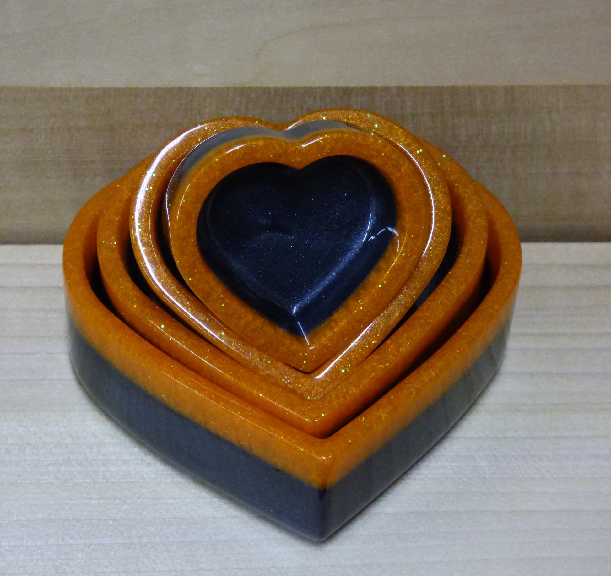 Set of four resin silver black and orange heart shaped dishes 
